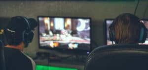 Gamers playing in front of monitors