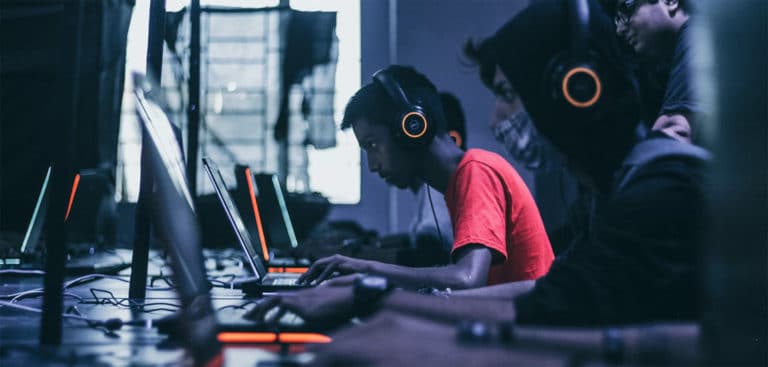 man playing on laptop - esports injuries