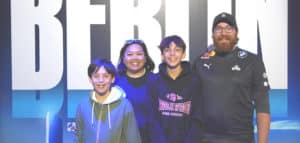 The Wonneberger family pose in the Riot Games Arena in Berlin at Worlds 2024 as League of Legends fans
