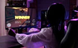 Esports tournaments global phenomena - woman playing PC game
