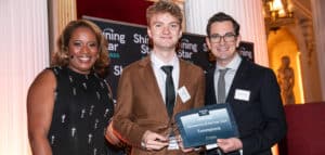 TommyInnit wins Sarcoma UK award from host Charlene White and Mark Hiley of The Analyst (photo credit: Kois Miah)