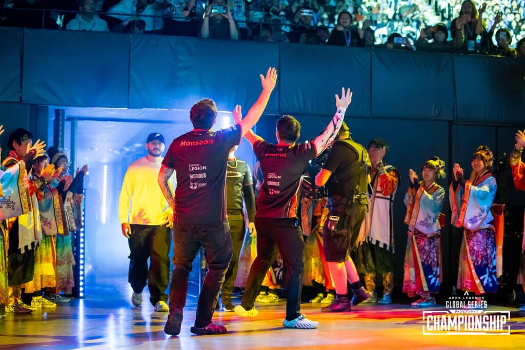 Complexity Gaming players Monsoon and Kimchilee enter the ALGS Year 4 Championship arena, arms upheld and looking back at the crowd who are supporting them.