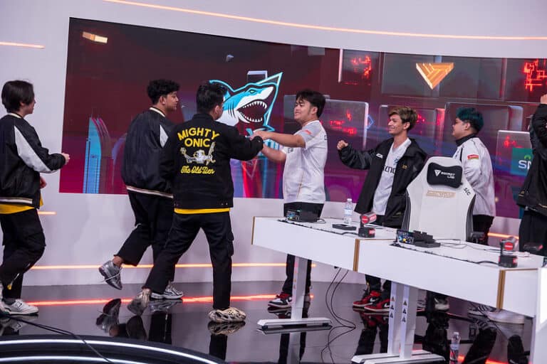 MLBB Esports World Cup stage, featuring placers walking to fist-bump each other after playing a match