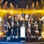 Mongolian Counter Strike team The MongolZ lift the Esports World Cup trophy, surrounded by gold confetti with their team logo projected on screens behind them
