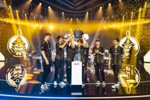 Mongolian Counter Strike team The MongolZ lift the Esports World Cup trophy, surrounded by gold confetti with their team logo projected on screens behind them
