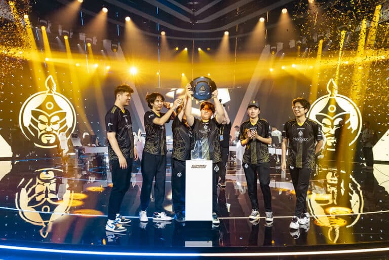 Mongolian Counter Strike team The MongolZ lift the Esports World Cup trophy, surrounded by gold confetti with their team logo projected on screens behind them