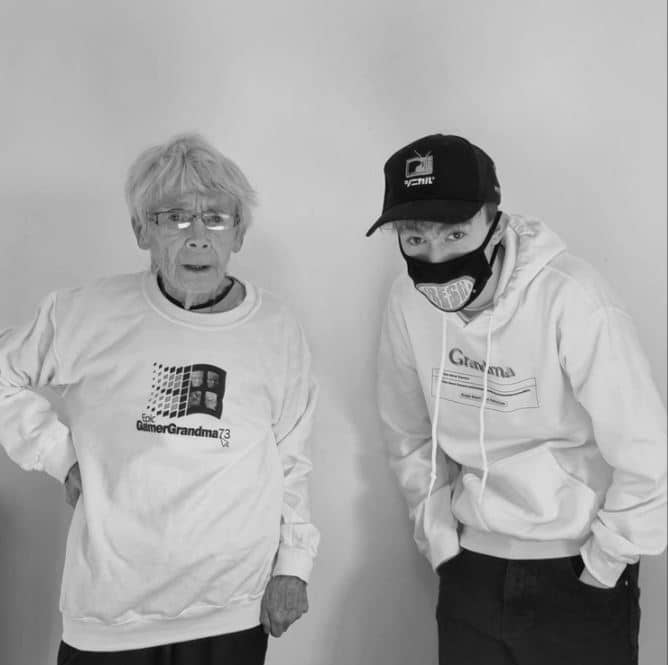 Epic Gamer Grandma stands with her grandson, wearing her merchandise.