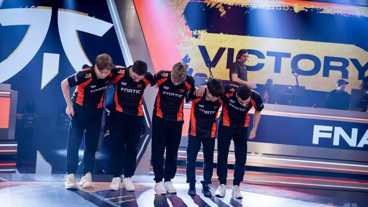 Fnatic esports team celebrating victory on stage after a match.