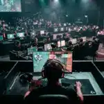 Esports tournament arena with players competing at illuminated gaming stations in professional Oceania venue