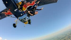 Mongraal skydiving from a red bull plane.