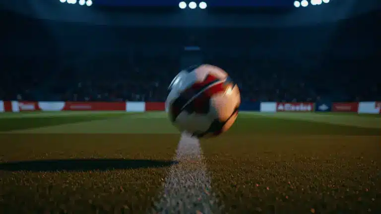 Football boot striking ball on floodlit pitch at evening kick-off, stadium shadows and crowd silhouettes.